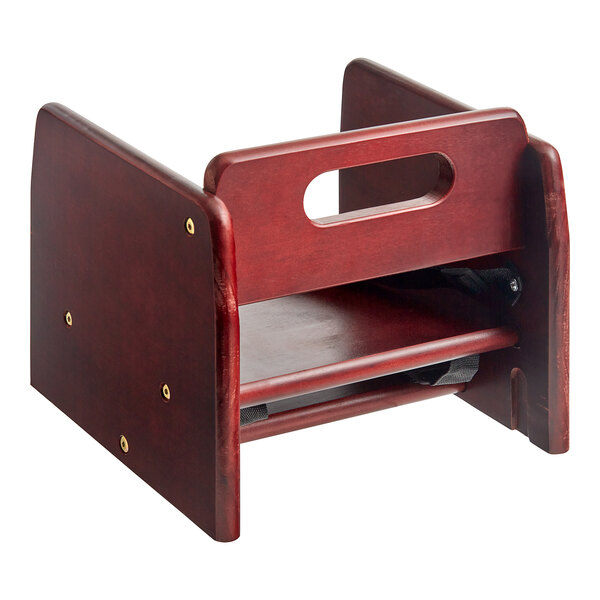 A Lancaster Table & Seating wooden booster seat with a hole in the middle.