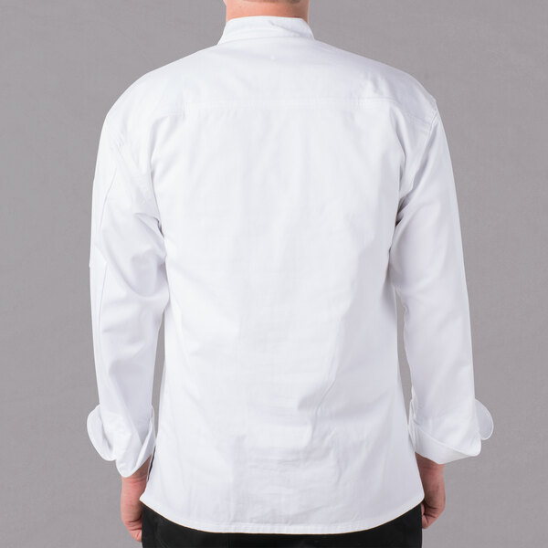 A man wearing a Mercer Culinary white long sleeve chef jacket with cloth knot buttons.