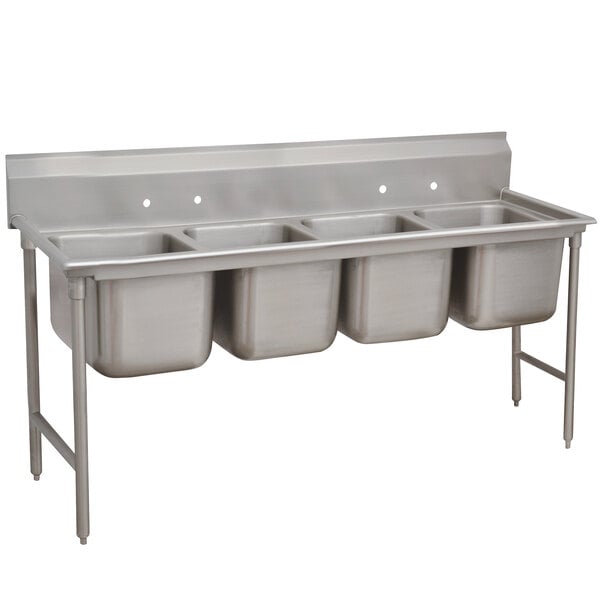 An Advance Tabco stainless steel sink with four compartments.