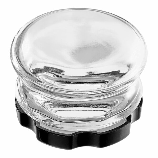 A clear glass container with a black plastic cap.