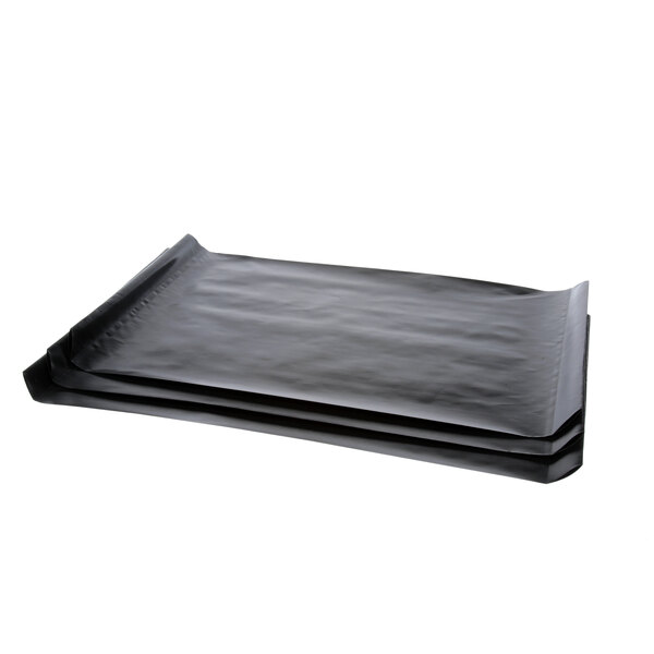 A stack of black Teflon sheets with a plastic cover on top.