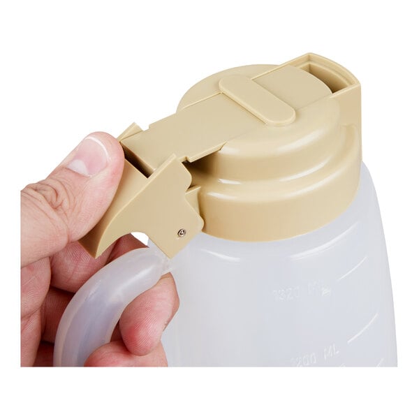 A black fan motor with three blades, a protective wire guard, and attached electrical wiring.