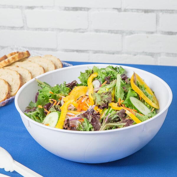 A Fineline white plastic round bowl filled with a vegetable salad.