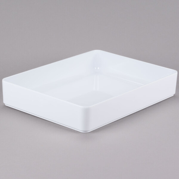 A white rectangular GET Milano deli crock with a lid on a gray surface.