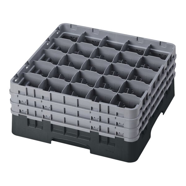 A black plastic Cambro glass rack with 25 compartments and 3 extenders.