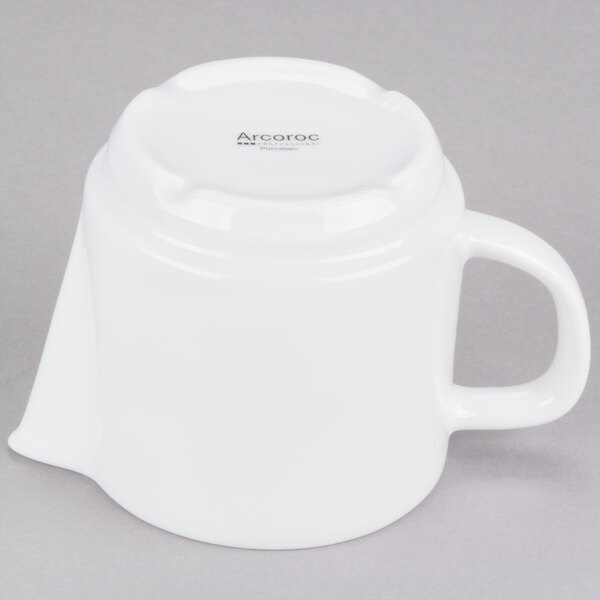 A white porcelain teapot with a lid and handle.