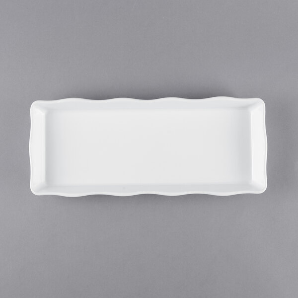 A white rectangular tray with a scalloped edge.
