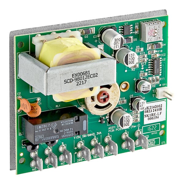 A close up of a green Cleveland thermostat circuit board with many small metal components.