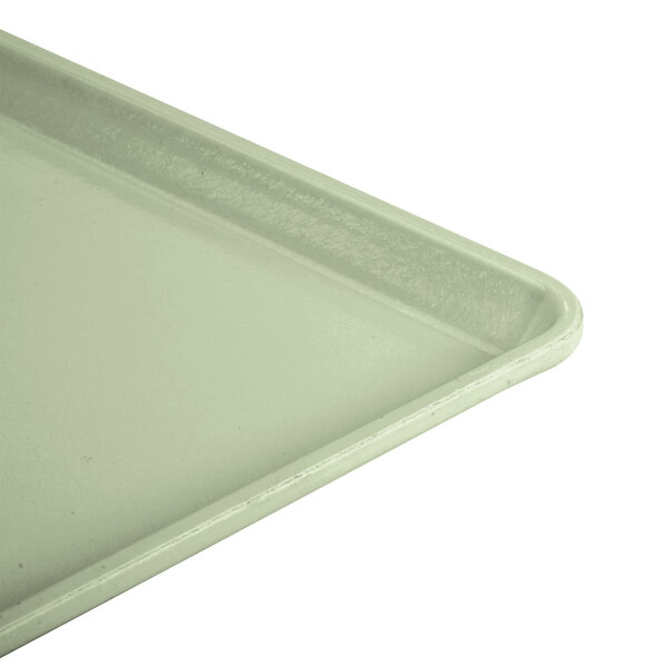 A close-up of a key lime Cambro dietary tray.