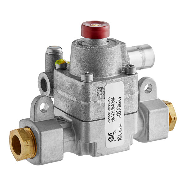 A silver metal Vulcan safety valve with a red button.