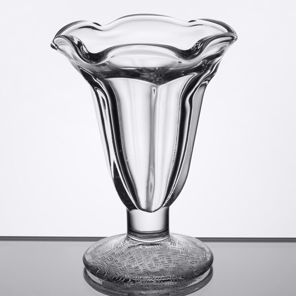 A clear Libbey tulip sundae glass with a swirly bottom and curved edge.