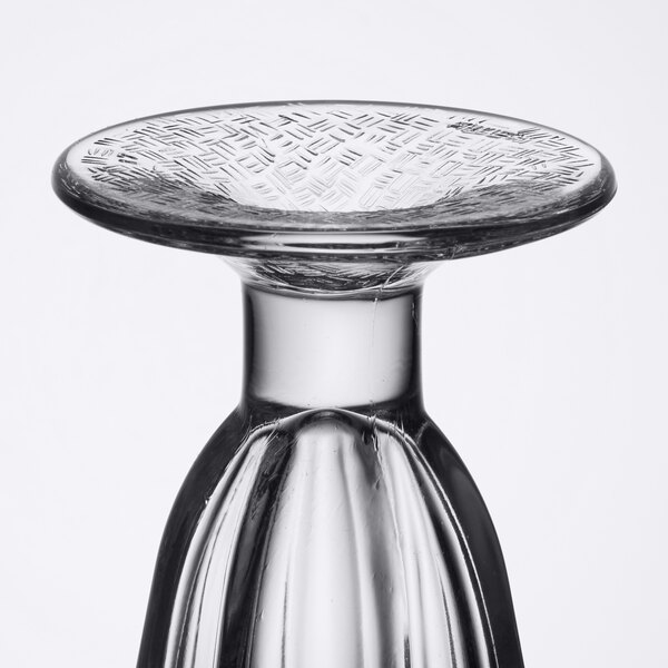 A close-up of a clear Libbey tulip sundae glass with a design on it.