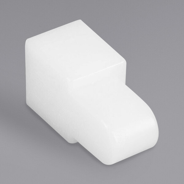 A white plastic Jet Tech door pin switch on a gray background.