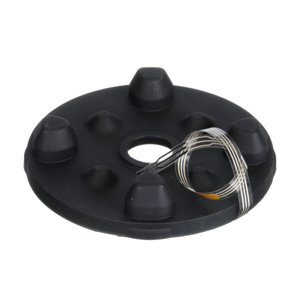 A black circular disc with wires attached to it.