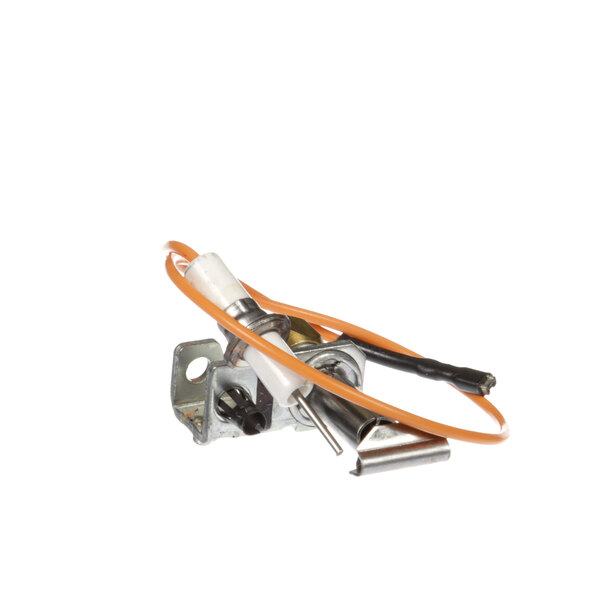 A Lang pilot burner with orange and white wires connected to a small metal object.