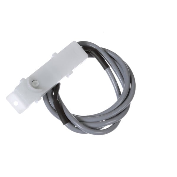 A white and grey cable with a black connector attached to a white plastic device.