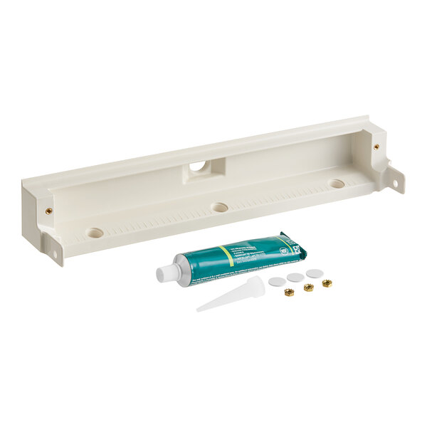 A white plastic shelf with a hole and tube.