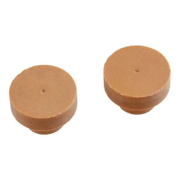 A pair of brown Manitowoc Ice water plugs.