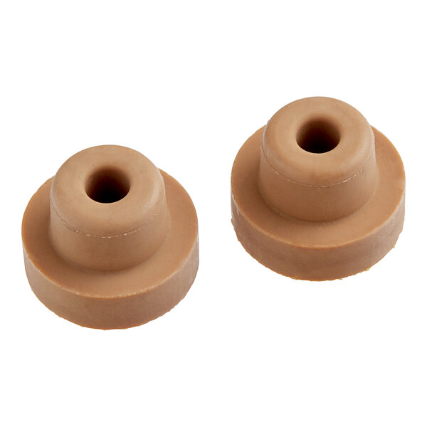 A pair of brown rubber Manitowoc Ice water plugs.