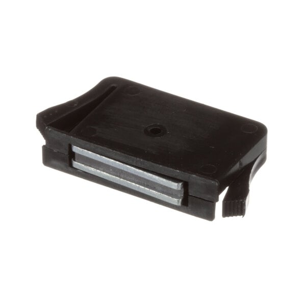 A black plastic piece with a metal strip and a small hole.