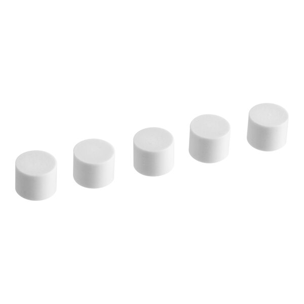 A row of white cylinder shaped caps.