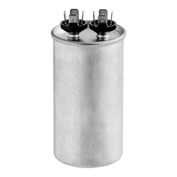 A close-up of a silver round metal capacitor with black caps.