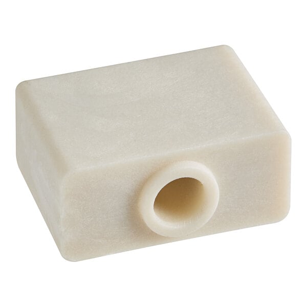 A white plastic square with a hole in it.