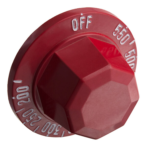 A red plastic Vulcan knob with white text.
