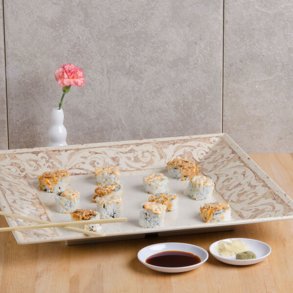 A GET Olympia melamine square plate with sushi, chopsticks, and sauces.