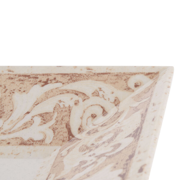 A close up of a white and brown square melamine plate with a design.