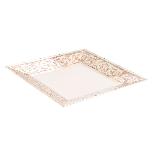 A close-up of a white square melamine plate with a gold design.