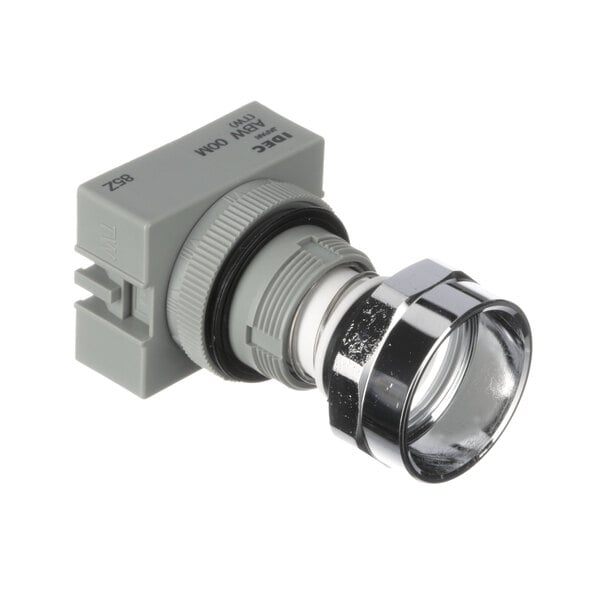 A close-up of a grey electrical device with a metal ring.