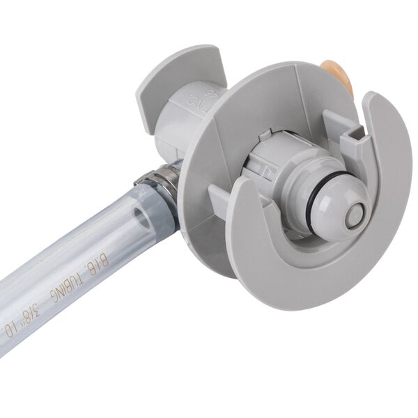 A close up of a grey plastic Coke machine adapter.