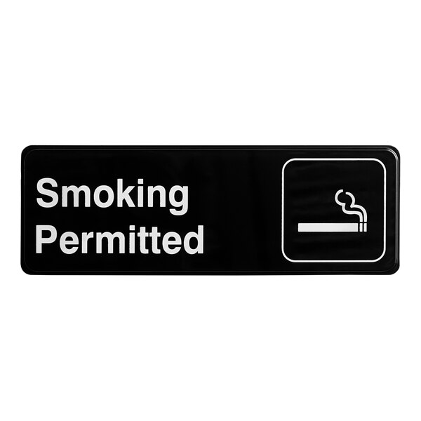 A black and white Thunder Group sign that says "Smoking Permitted"