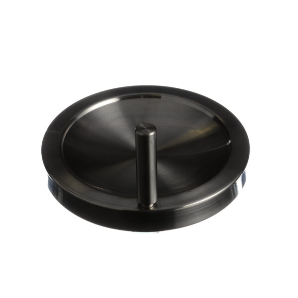 A close-up of a black metal handwheel with a stick.