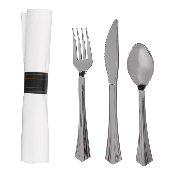 A set including a rolled white linen-feel napkin with a black band, a plastic fork, knife, and spoon with a stainless steel look.