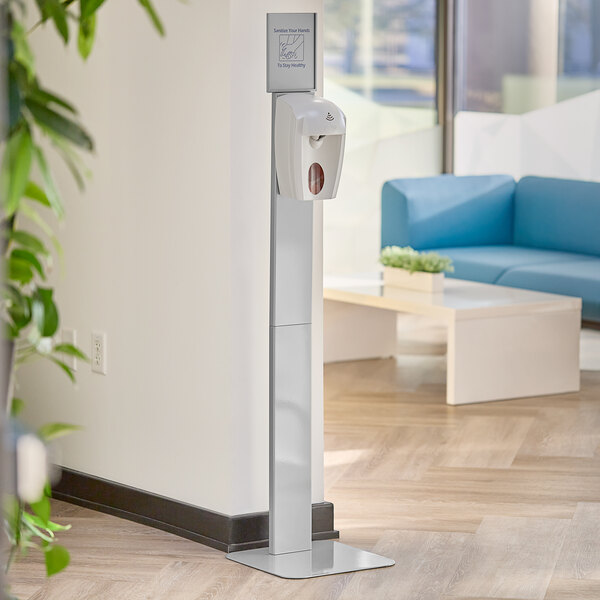 A Kutol Health Guard hand sanitizer dispenser stand in a corporate office room.