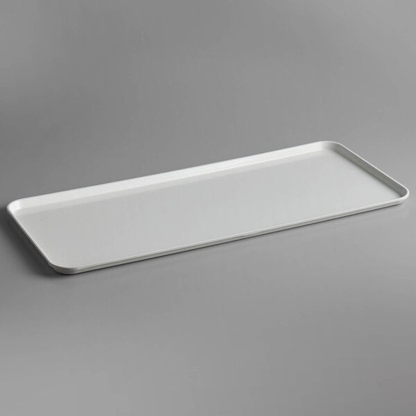 A white rectangular Cambro market tray on a gray surface.