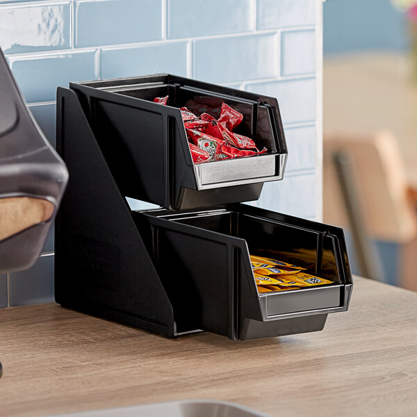 A black Vollrath condiment bin stand with 8" bins on a table.