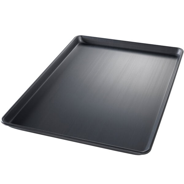 A Chicago Metallic BAKALON wire in rim aluminum sheet pan with a black rectangular tray.