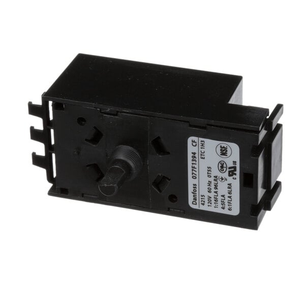 A black plastic Dan Foss controller with a white label.