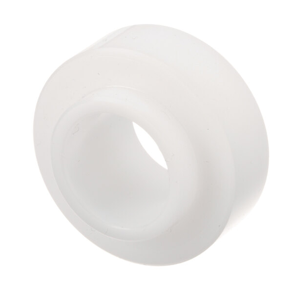 A white plastic round bushing with a hole in it.