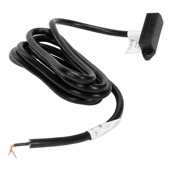 A black cable with a white label and an orange wire attached to the Jackson Door Switch.