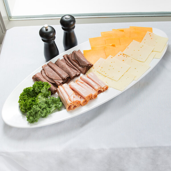 An American Metalcraft oval melamine boat platter with meat and cheese on it.