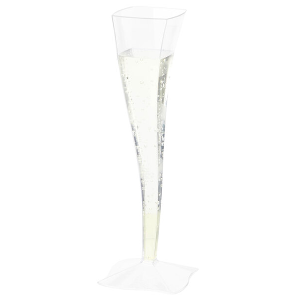 A clear Fineline Wavetrends plastic champagne flute with a clear liquid and bubbles.
