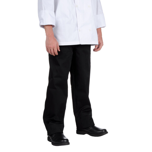 The lower half of a person wearing black Chef Revival chef pants.
