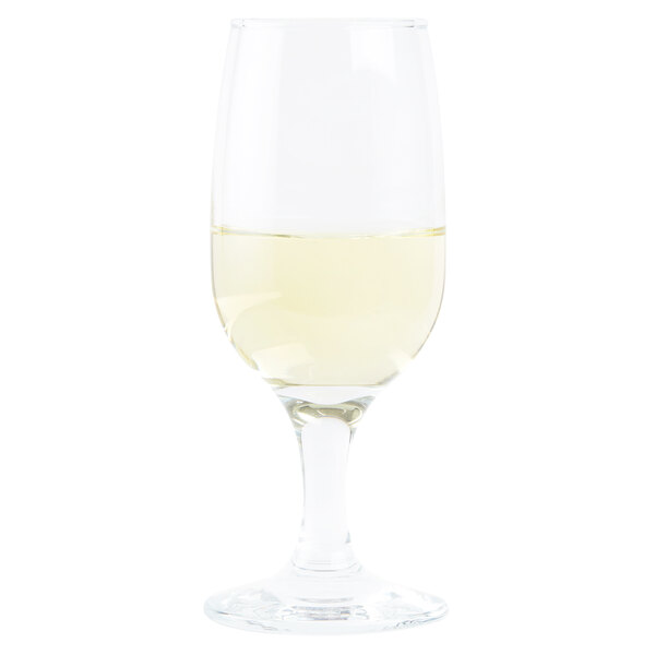 An Anchor Hocking Excellency wine glass filled with white wine.