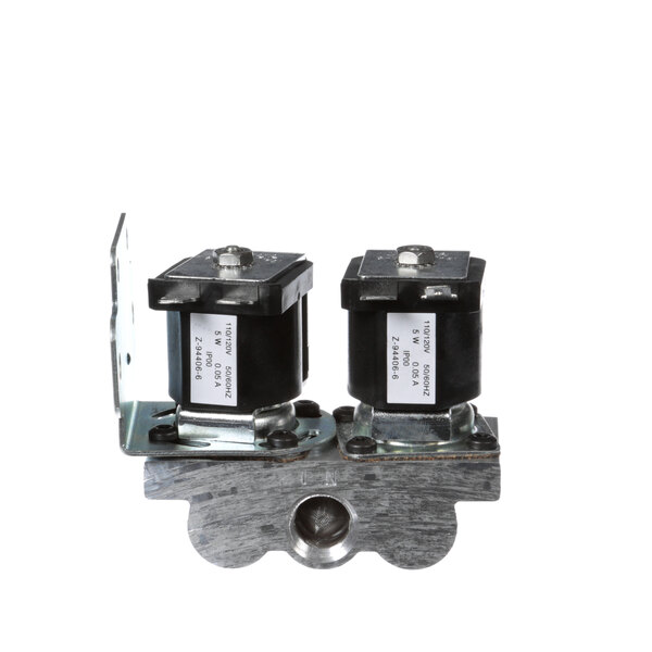 A close-up of a Vulcan dual solenoid valve with two black electrical switches.