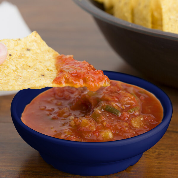 a chip with salsa on it