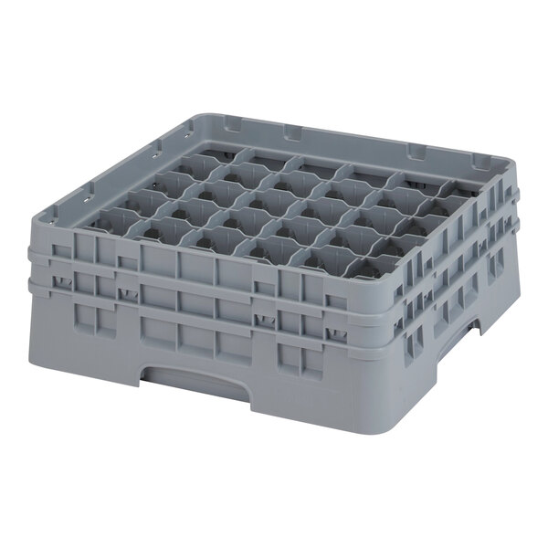 A soft gray plastic Cambro glass rack with many compartments and holes.